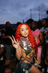 a woman with red hair posing in front of a crowd