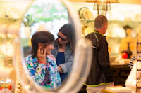 a woman looking at a mirror in a store