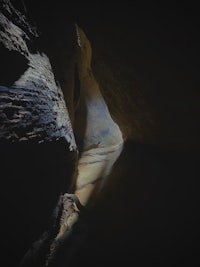 an image of a dark cave with a light shining through it