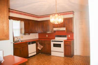 a kitchen with wooden cabinets and a stove