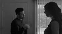 a man and woman standing in front of a door