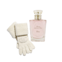 a bottle of perfume and gloves next to it