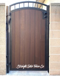 a wooden gate with a brown door