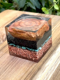 a wooden box with a piece of wood and sand in it