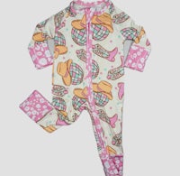 a baby girl's pink and white onesie with a cowboy hat on it