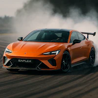 the orange sports car is driving on a track