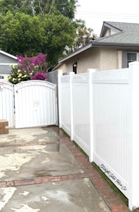 a white fence in front of a house