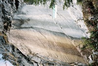a man is riding a snowboard on a rock
