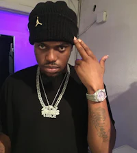a man wearing a black beanie with a ring on his finger