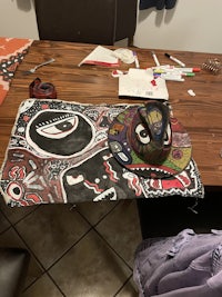 a wooden table with a piece of art on it