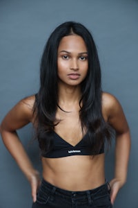 a woman in a black bra top posing for a photo