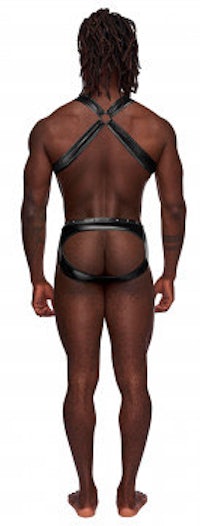 the back view of a black man wearing a leather harness