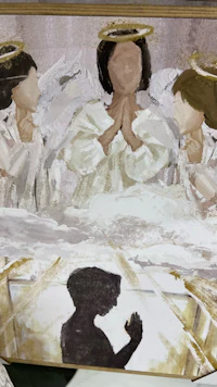 a painting of angels on a table
