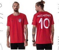 a man wearing a red t - shirt with the number 10 on it