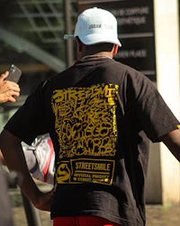 a man wearing a hat and a tee shirt