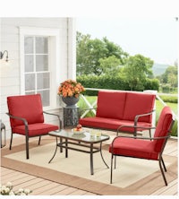a red patio furniture set on a porch