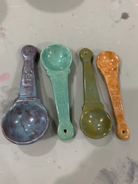 a group of colorful ceramic spoons on a table