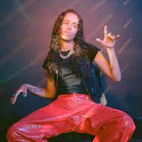 a woman in red leather pants posing for a photo