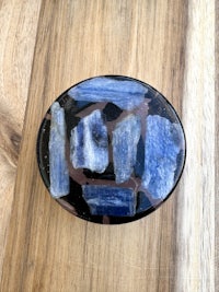 a blue stone ring on a wooden table