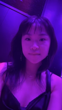 a woman in a purple dress posing for a photo