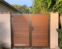a wooden gate with a brown finish