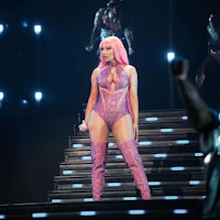 nicki minaj performs on stage in a pink outfit