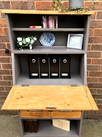 a grey desk with a bookcase on top