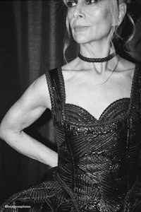 a black and white photo of a woman in a dress