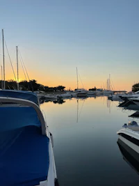 a boat docked in a marina at sunset