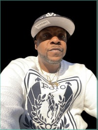 a man wearing a hat and a white sweater