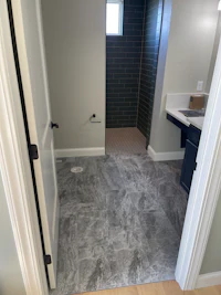 a bathroom with a tile floor and a door