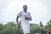a soccer player is standing on a soccer field