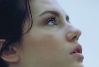 a close up of a woman looking up at the sky