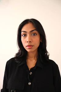 a woman in a black shirt is posing for a photo