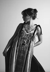 a black and white photo of a woman in a dress