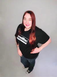a woman wearing a black t - shirt and jeans