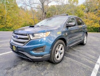a blue ford edge suv parked in a parking lot