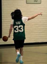 a man playing basketball in a gym