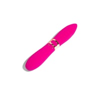 a pink vibrating toy on a white surface