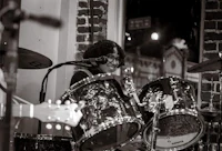 image may contain person, on stage and playing a musical instrument