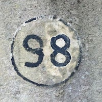 the number 89 is painted on a concrete wall