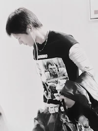 a young man wearing headphones and a t - shirt