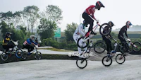 a group of people doing tricks on their bikes