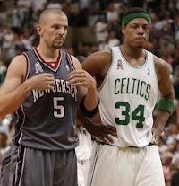 two basketball players standing next to each other