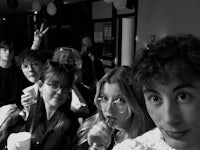 a black and white photo of a group of people at a party