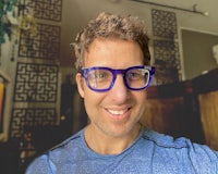 a man in glasses is taking a selfie