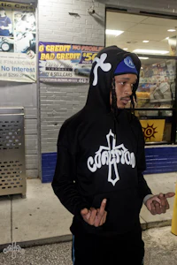 a man wearing a black hoodie