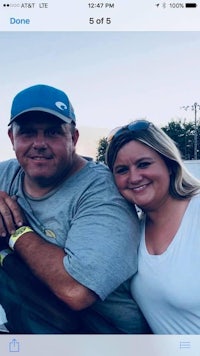 a man and woman posing for a photo in a car
