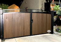 a wooden gate with a black and brown finish
