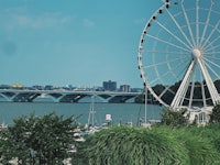 a ferris wheel in front of a waterway